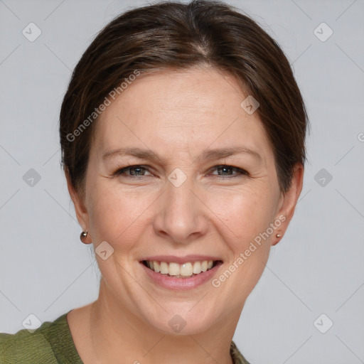 Joyful white adult female with short  brown hair and grey eyes