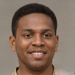 Joyful latino young-adult male with short  brown hair and brown eyes