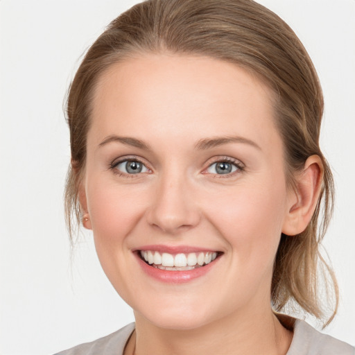 Joyful white young-adult female with medium  brown hair and blue eyes