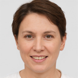 Joyful white adult female with short  brown hair and brown eyes