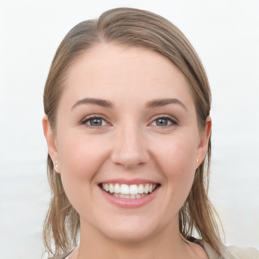 Joyful white young-adult female with long  brown hair and grey eyes