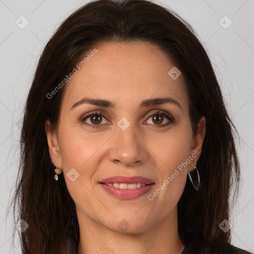 Joyful white adult female with long  brown hair and brown eyes