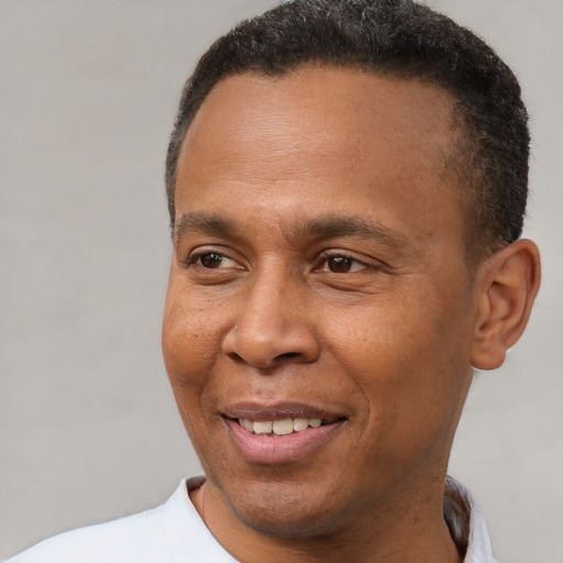 Joyful latino adult male with short  brown hair and brown eyes