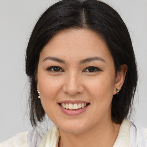 Joyful latino young-adult female with medium  brown hair and brown eyes