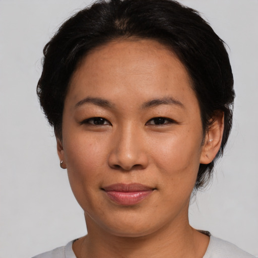 Joyful asian young-adult female with short  black hair and brown eyes