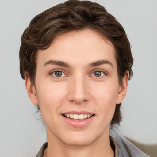 Joyful white young-adult female with short  brown hair and grey eyes