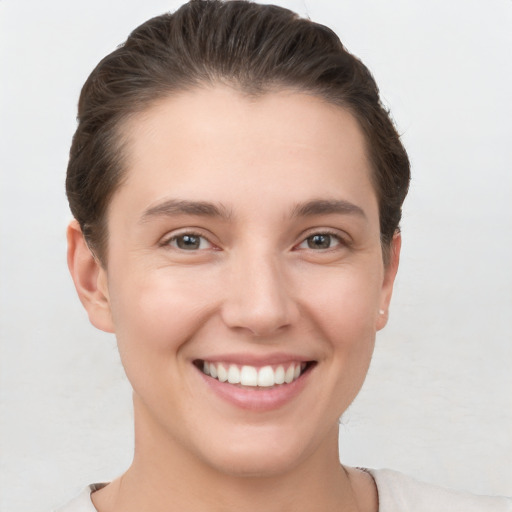 Joyful white young-adult female with short  brown hair and brown eyes