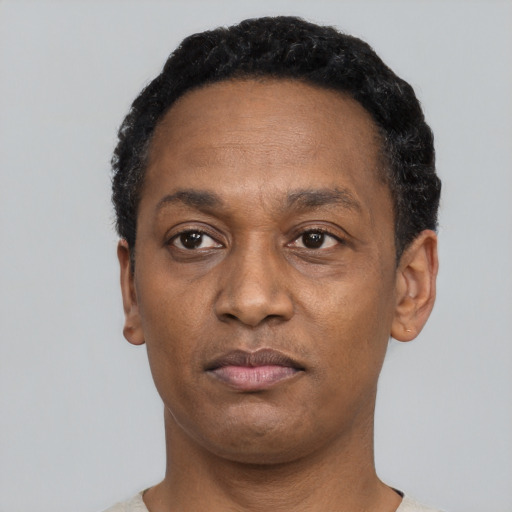 Neutral latino adult male with short  black hair and brown eyes