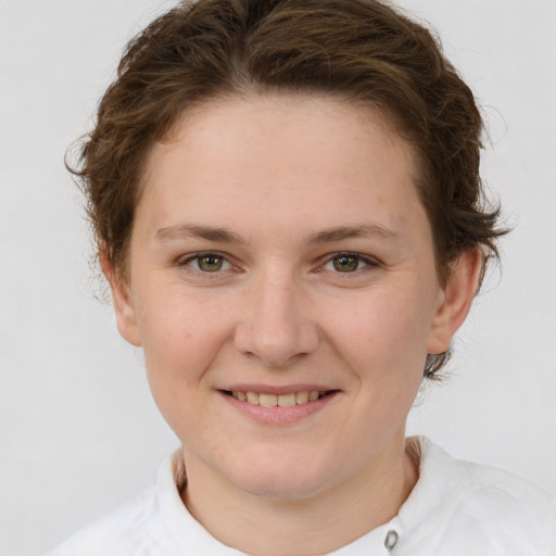 Joyful white young-adult female with short  brown hair and green eyes