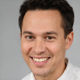 Joyful white adult male with short  brown hair and brown eyes