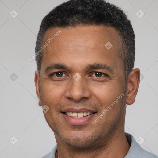 Joyful latino adult male with short  brown hair and brown eyes