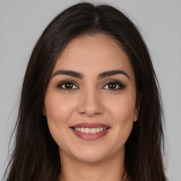 Joyful white young-adult female with long  brown hair and brown eyes