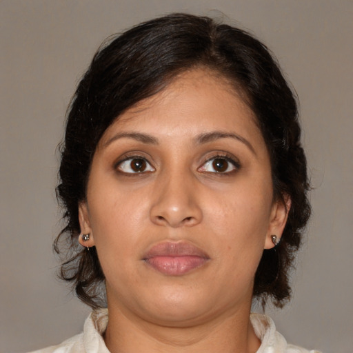 Neutral latino adult female with medium  brown hair and brown eyes