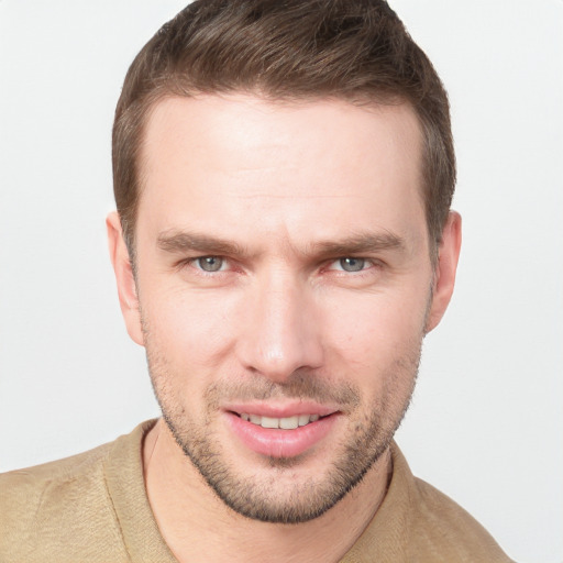 Joyful white young-adult male with short  brown hair and grey eyes