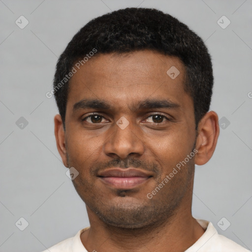 Joyful black young-adult male with short  black hair and brown eyes