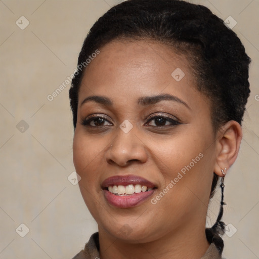 Joyful black young-adult female with short  brown hair and brown eyes