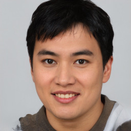 Joyful asian young-adult male with short  black hair and brown eyes