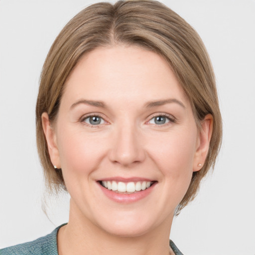 Joyful white young-adult female with medium  brown hair and blue eyes