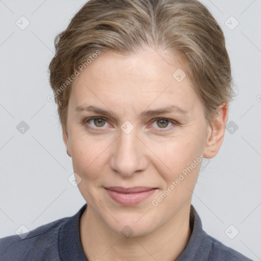 Joyful white adult female with medium  brown hair and grey eyes