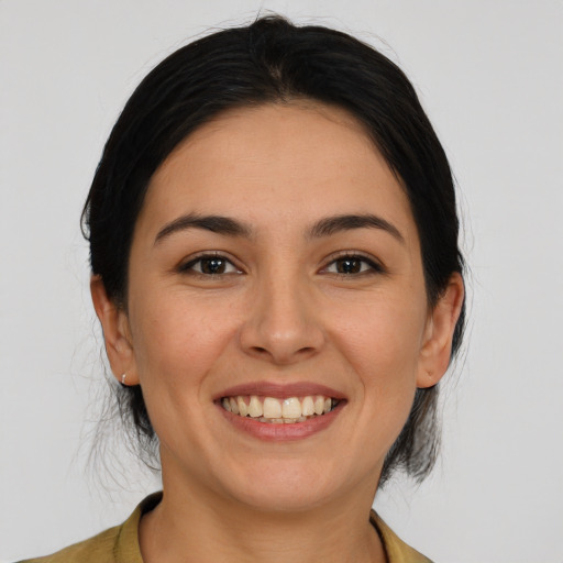 Joyful latino young-adult female with medium  brown hair and brown eyes