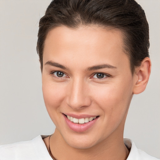 Joyful white young-adult female with short  brown hair and brown eyes