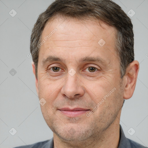 Joyful white adult male with short  brown hair and brown eyes