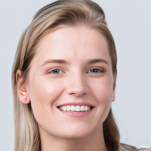 Joyful white young-adult female with long  brown hair and blue eyes