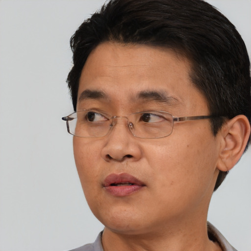 Neutral asian adult male with short  black hair and brown eyes