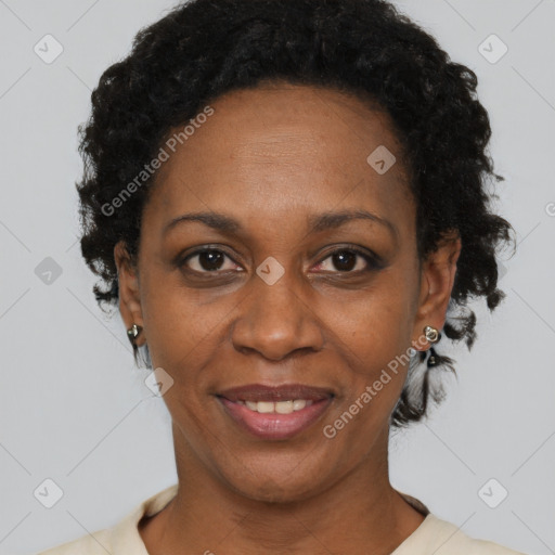 Joyful black adult female with short  black hair and brown eyes