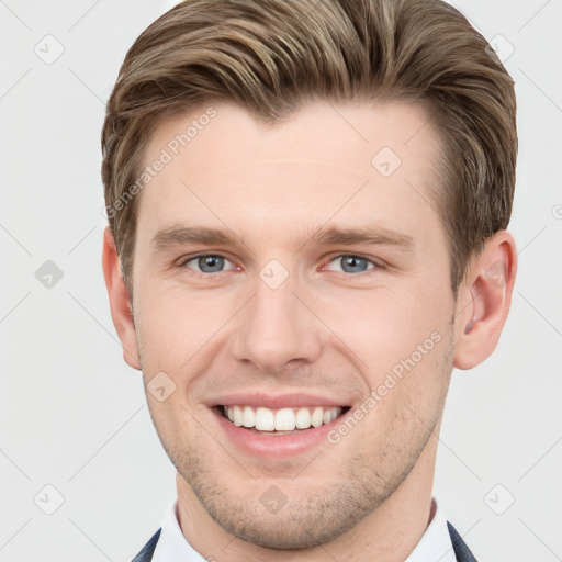 Joyful white young-adult male with short  brown hair and grey eyes