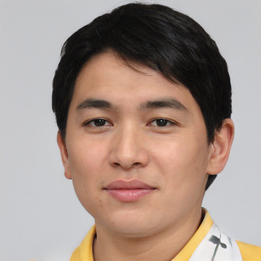Joyful asian young-adult male with short  black hair and brown eyes