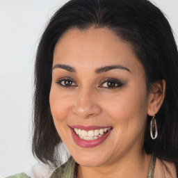 Joyful latino young-adult female with medium  brown hair and brown eyes