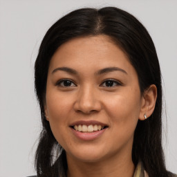 Joyful latino young-adult female with long  brown hair and brown eyes