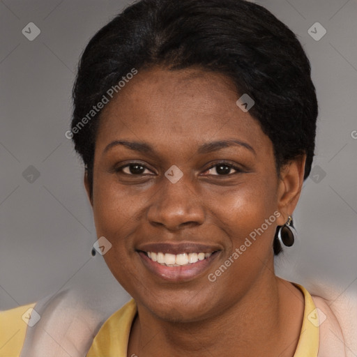 Joyful black young-adult female with short  black hair and brown eyes