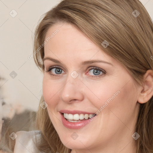 Joyful white young-adult female with long  brown hair and grey eyes