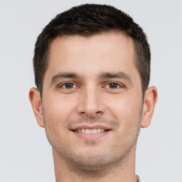 Joyful white young-adult male with short  brown hair and brown eyes