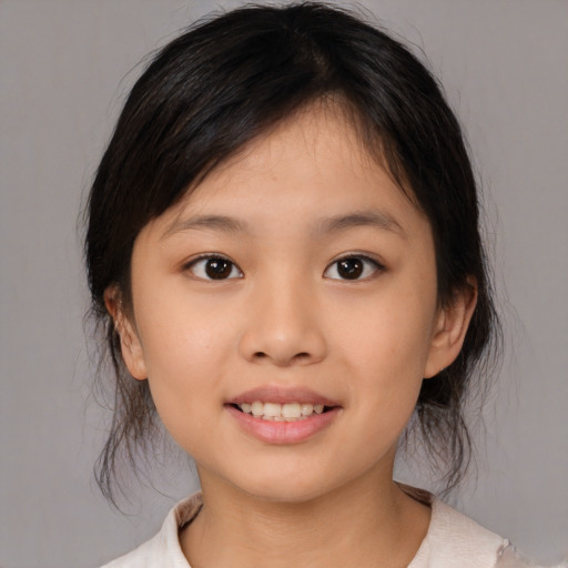 Joyful asian child female with medium  brown hair and brown eyes