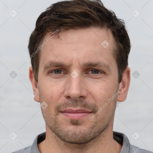 Joyful white adult male with short  brown hair and grey eyes