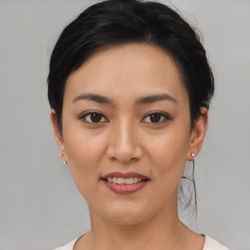 Joyful white young-adult female with short  black hair and brown eyes