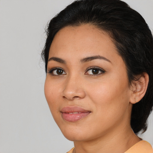 Joyful latino young-adult female with medium  black hair and brown eyes
