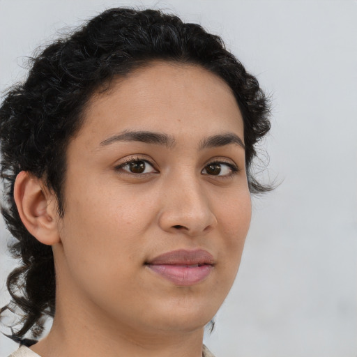 Joyful latino young-adult female with medium  brown hair and brown eyes