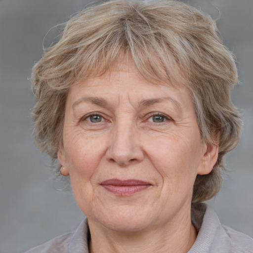 Joyful white middle-aged female with medium  brown hair and grey eyes