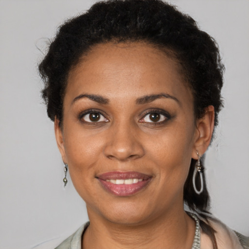 Joyful black young-adult female with short  brown hair and brown eyes