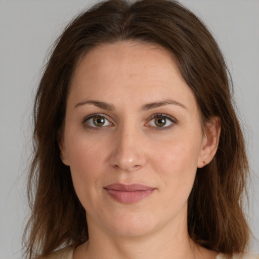 Joyful white adult female with long  brown hair and brown eyes