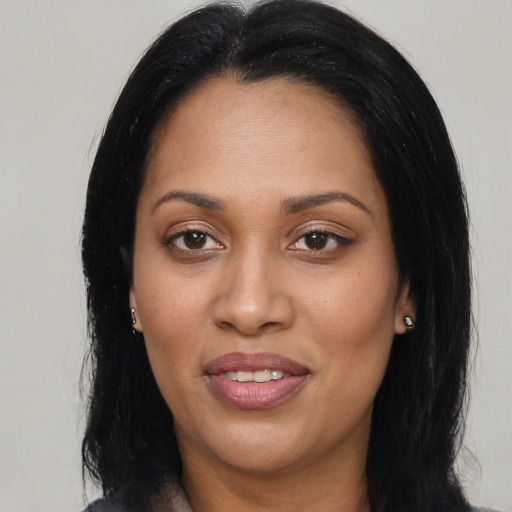 Joyful latino adult female with long  black hair and brown eyes