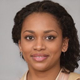 Joyful black young-adult female with medium  brown hair and brown eyes