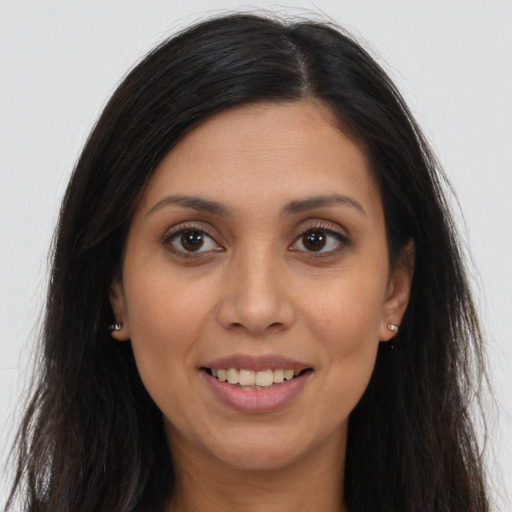 Joyful white young-adult female with long  brown hair and brown eyes