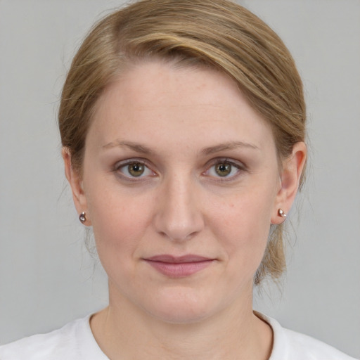 Joyful white young-adult female with medium  brown hair and blue eyes