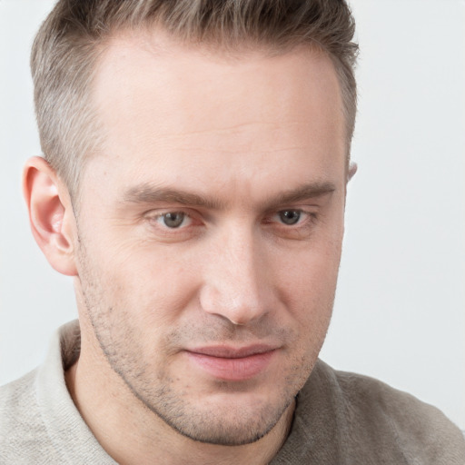 Joyful white adult male with short  brown hair and grey eyes