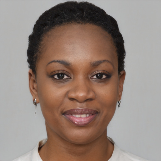 Joyful black young-adult female with short  brown hair and brown eyes